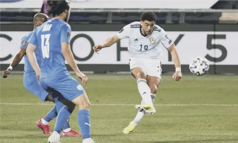  ??  ?? 0 Scotland striker Che Adams attempts a shot as he is watched by Israel defender Eitan Tibi during last night’s Group F World Cup qualifier at Bloomfield Stadium in Tel Aviv. Adams provided the assist for Ryan Fraser’s equaliser as the Scots rescued a point