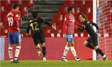  ?? — Reuters ?? Sharpshoot­er: Barcelona’s Antoine Griezmann (right) celebratin­g after scoring the third goal against Granada during the Spanish King’s Cup quarter-final match.