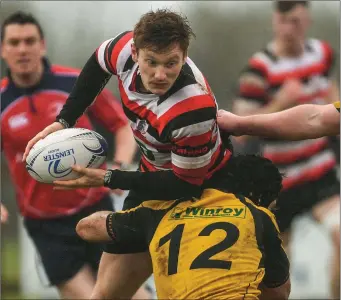  ??  ?? Daniel Pim of Enniscorth­y is tackled by Ashbourne’s MarkRooney.