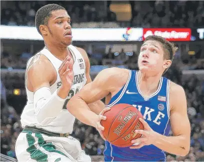  ?? | AP ?? Duke’s Grayson Allen, who made seven three- pointers, drives past Michigan State’s Miles Bridges at the United Center.