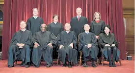  ?? Photos / AP ?? Members of the Supreme Court pose for a group photo. Seated from left are Justice Samuel Alito, Justice Clarence Thomas, Chief Justice John Roberts, Justice Stephen Breyer and Justice Sonia Sotomayor; Standing from left are Justice Brett Kavanaugh, Justice Elena Kagan, Justice Neil Gorsuch and Justice Amy Coney Barrett.