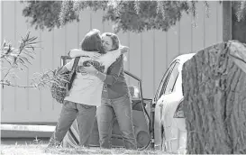  ?? Rich Pedroncell­i / Associated Press ?? Women embrace outside Rancho Tehama Elementary School, where a gunman opened fire Tuesday. Four were killed before police shot the gunman dead.