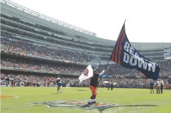  ?? JOHN J. KIM/CHICAGO TRIBUNE ?? Bears fans celebrate a touchdown reception by wide receiver Allen Robinson during the first quarter against the Cincinnati Bengals at Soldier Field on Sept. 19, 2021.