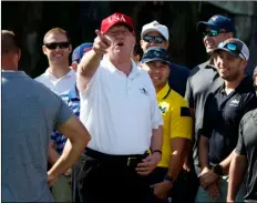  ??  ?? President Donald Trump speaks as he meets with members of the U.S. Coast Guard, who he invited to play golf, at Trump Internatio­nal Golf Club on Friday in West Palm Beach, Fla. AP PHOTO