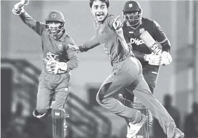  ?? PHOTO BY WICB MEDIA/RANDY BROOKS ?? Afghanista­n’s Rashid Khan (centre) celebrates after he trapped West Indies’ Ashley Nurse leg before wicket in the first One-Day Internatio­nal at Darren Sammy National Cricket Stadium, Gros Islet, St Lucia on Friday night.