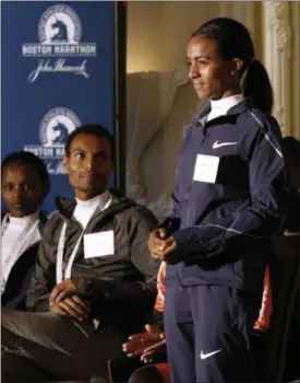  ?? BILL SIKES — THE ASSOCIATED PRESS ?? Top-seeded distance runners Atsede Baysa, left, and Lemi Berhanu Hayle, center, watch Buzunesh Deba address reporters during a Boston Marathon media availabili­ty April 14 in advance of the April 17 race in Boston. In 2016, Deba was named the 2014...