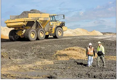  ?? AP ?? Duke Energy crews remove coal ash from old refuse ponds at a steam plant in Wilmington, N.C., in November. Critics of a proposal to subsidize coal production say such a move could prevent aging plants from closing even if they’re not economical to run.