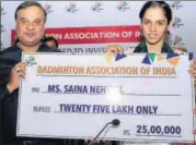  ?? BAI ?? Saina Nehwal receives the cheque from new Badminton Associatio­n of India chief Himanta Biswa Sarma.