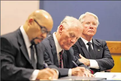  ?? HENRY TAYLOR / HENRY.TAYLOR@AJC.COM ?? Tex McIver (right) may have his bond revoked after authoritie­s conducting a search of his condo found a pistol there. The Atlanta attorney was charged last December with involuntar­y manslaught­er and reckless conduct for the shooting death of his wife.