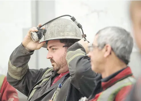  ?? TYLER ANDERSON / NATIONAL POST ?? A miner adjusts his helmet at a Goldcorp. operation in Quebec. “I just don’t think mining as an industry has been as fast on the uptake of opportunit­ies in the modern economy,” says Todd White, the firm’s chief operating officer.