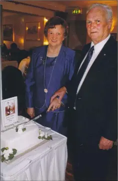  ??  ?? The late Anna and Michael Rowe cutting the cake to mark their 50th wedding anniversar­y five years ago.