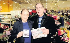  ??  ?? Lucky winner Billy receives his voucher from a Tesco’s Christie Henry