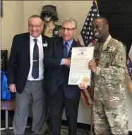  ?? PHOTO PROVIDED ?? Senator Jim Tedisco presents a congratula­tory citation to Captain Mark Saunders, joined by Capital Region Chamber Senior VP Pete Bardunias.