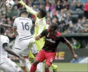  ?? MOLLY BLUE — THE ASSOCIATED PRESS (VIA THE OREGONIAN) ?? Union goalkeeper Andre Blake, in yellow, blocks the ball during a match against the Timbers Saturday in Portland, Ore.