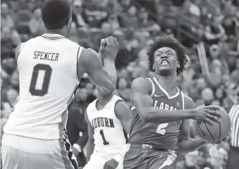  ?? THE ASSOCIATED PRESS ?? Alabama’s Collin Sexton, right, heads to the basket as Auburn’s Horace Spencer, left, defends during the second half of their quarterfin­al game in the SEC tournament Friday in St. Louis. Alabama won 81-63.