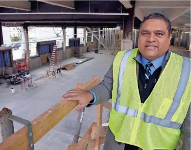  ?? RICK WOOD / MILWAUKEE JOURNAL SENTINEL ?? Alfonso Carmona, superinten­dent at St. Augustine Preparator­y Academy, 2607 S. 5th St., stands above the new commons area, which will serve as an entryway and cafeteria for students as well as host community and church services on Sundays.