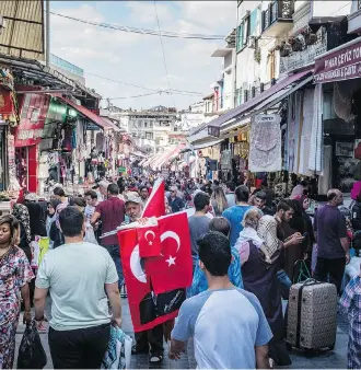  ?? CHRIS MCGRATH/GETTY IMAGES ?? A man sells Turkish flags in Istanbul on Thursday. Despite panic about the Turkey crisis, Turkey really doesn’t matter that much from an investment standpoint, writes Peter Hodson.