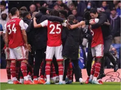  ?? ?? Mikel Arteta, right, celebrates with his team after their victory over Chelsea at Stamford Bridge