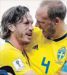  ?? PAVEL GOLOVKIN THE ASSOCIATED PRESS ?? Sweden’s Andreas Granqvist, right, and Gustav Svensson embrace after winning.