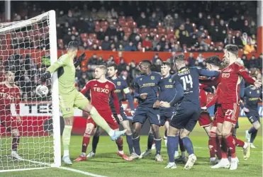  ?? ?? Dundee’s Lee Ashcroft heads into the net to ensure last night’s match at Pittodrie finished all square