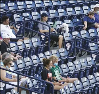  ?? Associated Press ?? FANS WELCOME — Fans are socially distanced during the first inning of a Low A Southeast League baseball game between the Dunedin Blue Jays and the Tampa Tarpons at George M. Steinbrenn­er Field on Tuesday in Tampa, Fla. Minor league baseball is starting back up after having their season canceled last year by the pandemic. The Tarpons were welcoming dogs at the game.