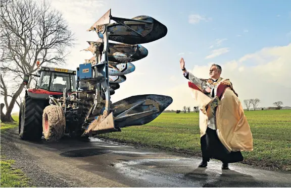  ?? ?? Faith in sod The Rev Andrew Birks blesses the plough of farmer Jonathan Pike outside St Mary’s church in Chidham, where the West Sussex community marked the start of the agricultur­al year with Plough Sunday. The ritual dates back to the Middle Ages, when ploughs were kept in the parish church in winter.