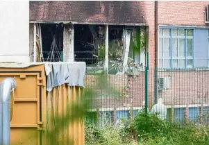  ??  ?? Breached premises: Members of an investigat­ion team analysing debris in front of the Brussels criminolog­y institute building after a car rammed through three fences, leading to an explosion and a large fire in the premises. — ePA