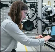  ??  ?? Orla at work in the lab, while below, with colleagues at the factory