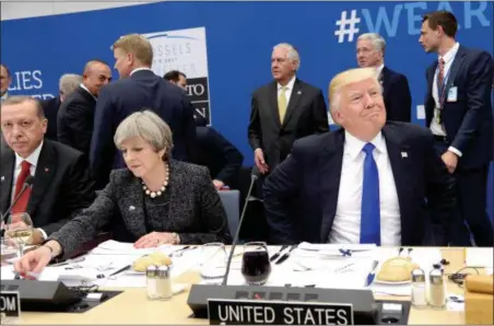  ?? THIERRY CHARLIER — POOL PHOTO VIA AP ?? President Donald Trump, right, reacts as he sits next to Britain’s Prime Minister Theresa May, center and Turkish President Recep Tayyip Erdogan as they participat­e in a working dinner meeting, during the NATO summit of heads of state and government,...