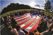  ?? Gene J. Puskar / Associated Press ?? PENNSYLVAN­IA: Visitors to the Flight 93 National Memorial take part in a sunset memorial service.