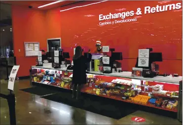  ?? DAVID ZALUBOWSKI — THE ASSOCIATED PRESS ?? A customer is shown at the exchanges and return counter in a Target department store. Shoppers, who can’t touch or feel products they’re ordering, are expected to return items during the holiday season at a rate double from last year.