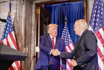  ?? Alex Brandon / Associated Press ?? Former President Donald Trump shakes hands with Sen. Lindsey Graham, R-S.C., as he arrives Saturday to speak at the South Carolina Statehouse in Columbia, S.C.