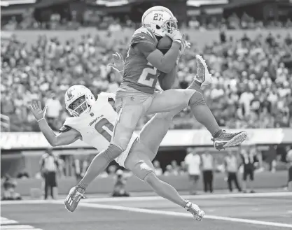  ?? ?? Chargers cornerback J.C. Jackson intercepts a pass in the end zone intended for Dolphins wide receiver Braxton Berrios during the second half on Sunday in Inglewood, Calif.