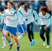  ?? — AFP ?? Cesc Fabregas (centre) of Chelsea and other players warm up ahead of the EPL match against Fulham in this file photo.