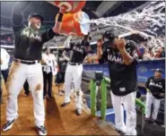  ?? WILFREDO LEE — THE ASSOCIATED PRESS ?? Miami Marlins’ Justin Bour, left, and Marcell Ozuna, center rear, pour ice and water onto starting pitcher Edinson Volquez, right, after the Marlins defeated the Arizona Diamondbac­ks 3-0 in a no-hitter by Volquez Saturday in Miami.