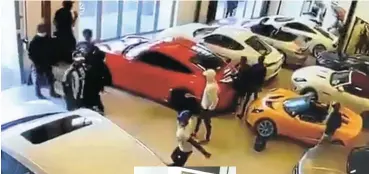  ??  ?? A video grab of the men who raided The Toy Shop dealership in Paarden Eiland and damaged several luxury cars.