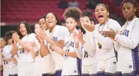  ?? BRIAN KRISTA/BALTIMORE SUN MEDIA ?? Pikesville players cheer for teammates as they accept their medals after beating Mountain Ridge, 38-33, to win a third straight Class 1A state title on Saturday at the University of Maryland’s Xfinity Center in College Park.