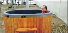  ??  ?? David Johnston, Auchrannie facilities and projects manager, tries out the prototype hot tub being made from Scottish larch in Forres.
