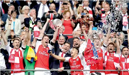  ?? — AP ?? Arsenal players celebrate their English FA Cup win over Chelsea at the Wembley Stadium in London on Saturday. Arsenal won 2-1.