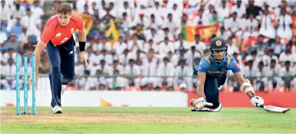  ??  ?? Lankan batsman Dasun Shanaka who top scored with a bright knock of 66, is run out. Pix by Priyantha Wickramaar­achchi