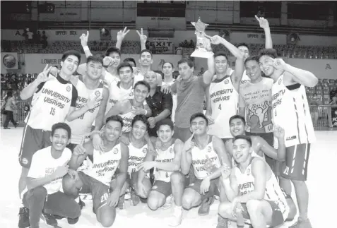  ??  ?? The UV Green Lancers led by their head coach Gary Cortes jubilate after winning the collegiate division championsh­ip of the 2018 CESAFI Partner's Cup with a two-game sweep of the UC Webmasters on Tuesday night at the Cebu Coliseum.