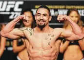  ?? ?? Robert Whittaker weighs in before his fight against middleweig­ht champion Israel Adesanya.