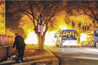  ?? Defne Karadeniz / Getty Images ?? Turkish army buses burn Wednesday after car bomb attack during Ankara’s rush hour. No group immediatel­y claimed responsibi­lity, but ISIS carried out an attack in October that killed 102.