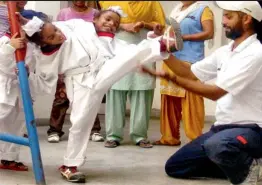  ?? — PTI ?? Conjoined twins Sohan Singh and Mohan Singh learn Taekwondo for self defence during a camp for special children in Amaritsar on Saturday.