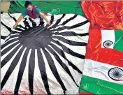  ?? SATISH BATE/HT PHOTO ?? A worker gives finishing touches to the 60x90 feet tricolour at a Byculla workshop, in Mumbai, on July 30.