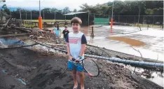  ??  ?? WASHED OUT: Tennis players Aidan Christophe­r and his sister and brother Mia Christophe­r and Lachlan Christophe­r on court.