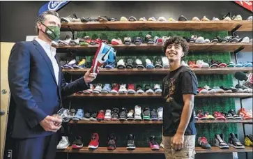  ?? Robert Gauthier Los Angeles Times ?? GOV. GAVIN NEWSOM meets Mario Rodriguez at the HypeBeast Kickz shoe store in San Fernando. To remove the governor from office, more than 50% of voters will need to cast their ballot in favor of the recall.