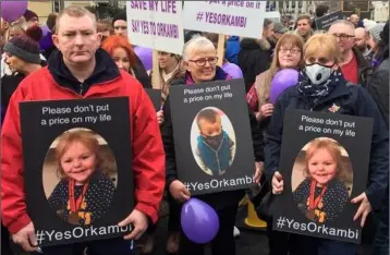  ??  ?? Karl and Julie Forster from Enniscorth­y holding posters of their daughter Ruth during last week’s Dáil protest over the cystic fibrosis drug Orkambi.