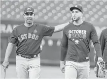  ?? Karen Warren / Houston Chronicle ?? Astros bench coach Alex Cora, left, with outfielder George Springer during Sunday’s workout at Yankee Stadium, is expected to interview for at least three managerial openings.