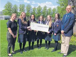  ??  ?? The Morrison’s pupils with their charity cheque.